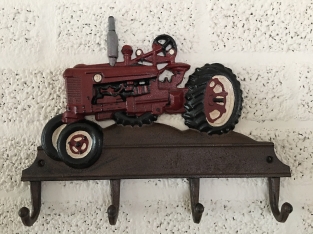 Farmhouse design coat rack with Farsnall agricultural tractor.